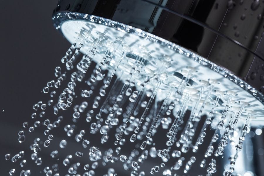 A shower exudes water. Heat Pump Water Heaters Included in Inflation Reduction Act.